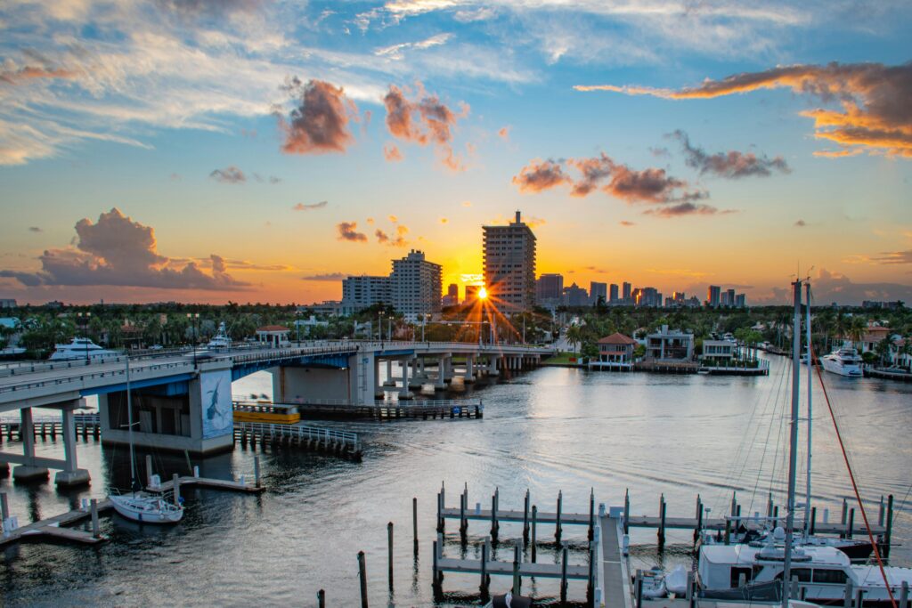 Picturesque sunrise over Las Olas Bridge in Fort Lauderdale, capturing the marina and skyline.